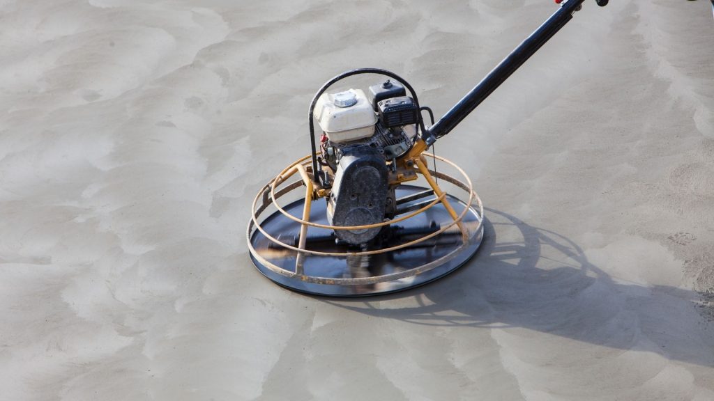 Power trowel machine finishing a freshly poured concrete surface