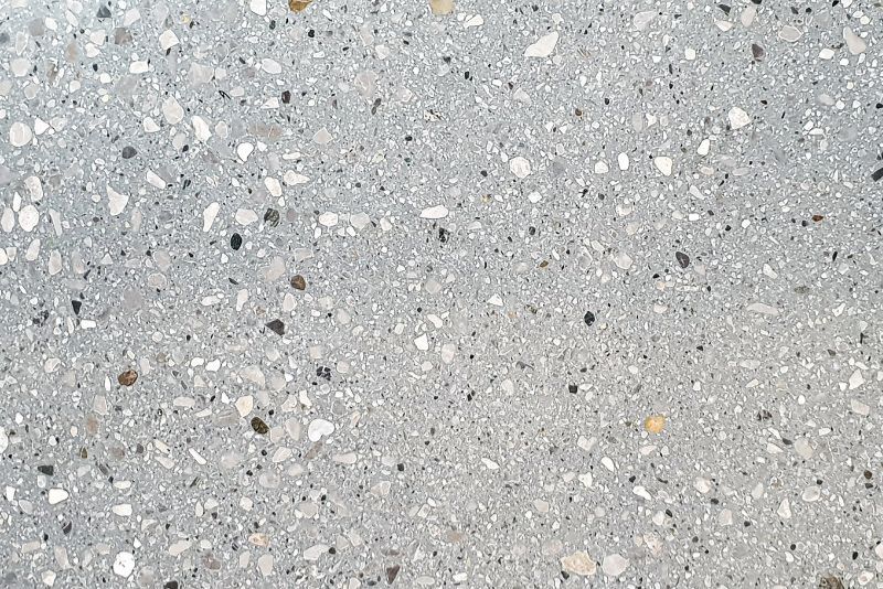 Close-up of polished exposed aggregate concrete with visible stone aggregate