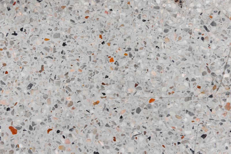 Close-up of polished terrazzo-style concrete with orange and grey stone aggregate